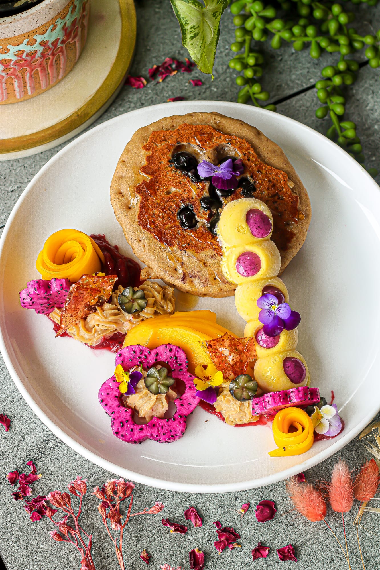 Vegan pancakes with blueberries, mango rose, dragon fruit, nice-cream and edible flowers