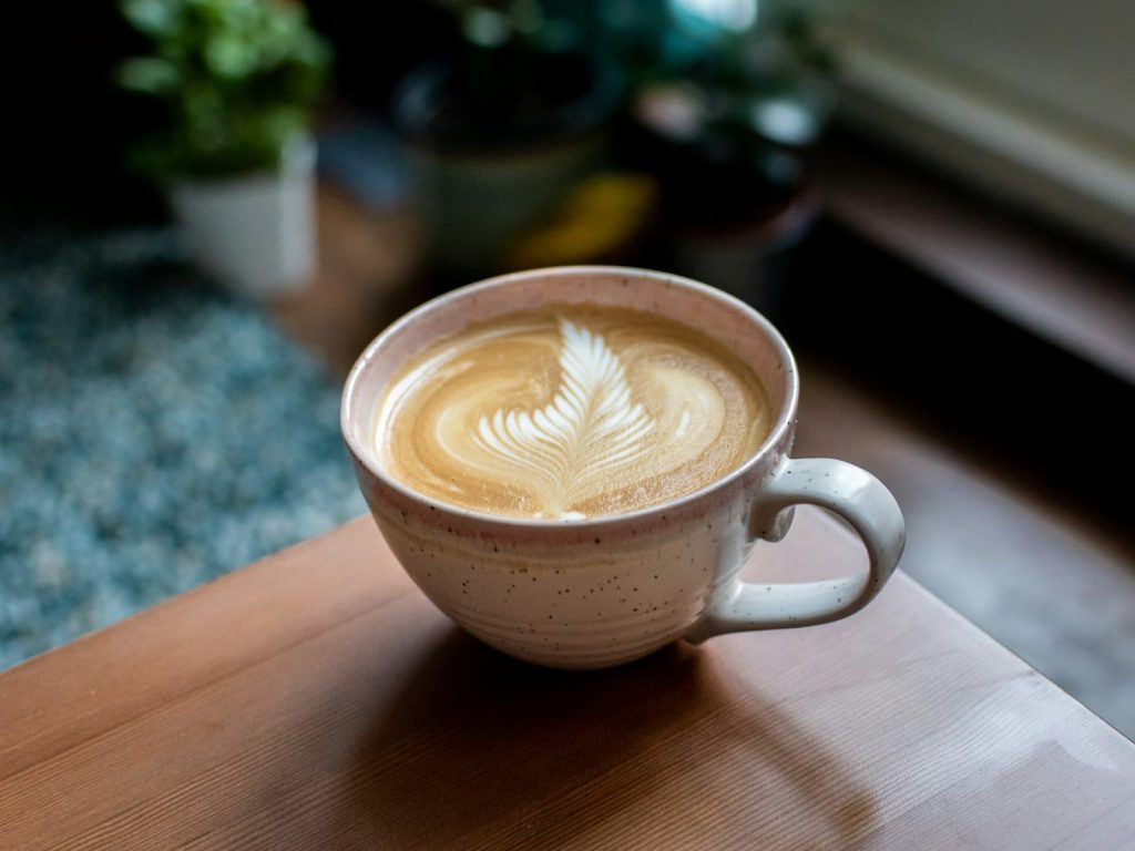 Oat milk latte art in a coffee cup