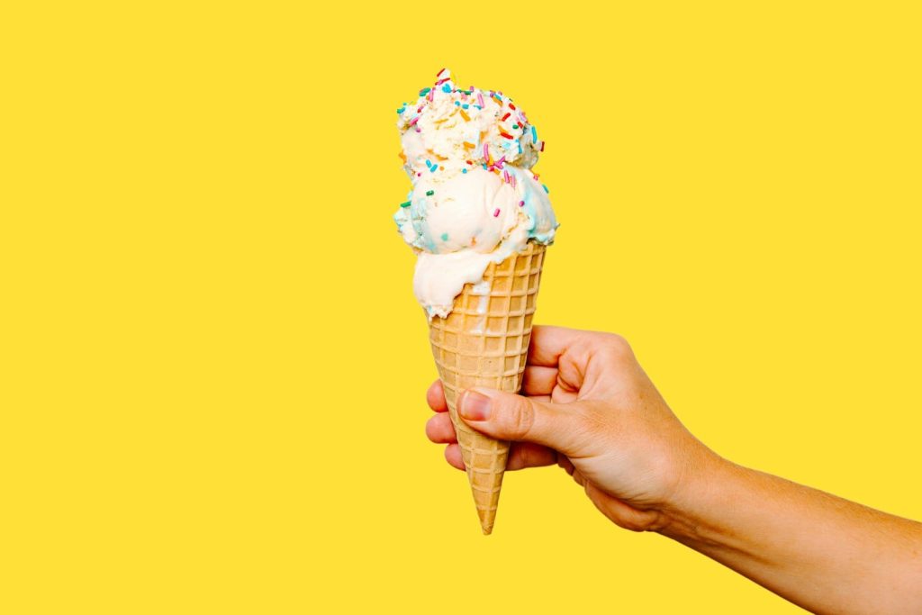 A scoop of vegan ice cream in a cone